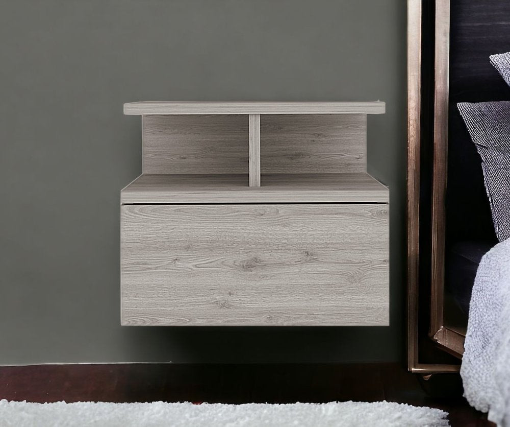 Grey floating bedside table on a wall next to a bed 
