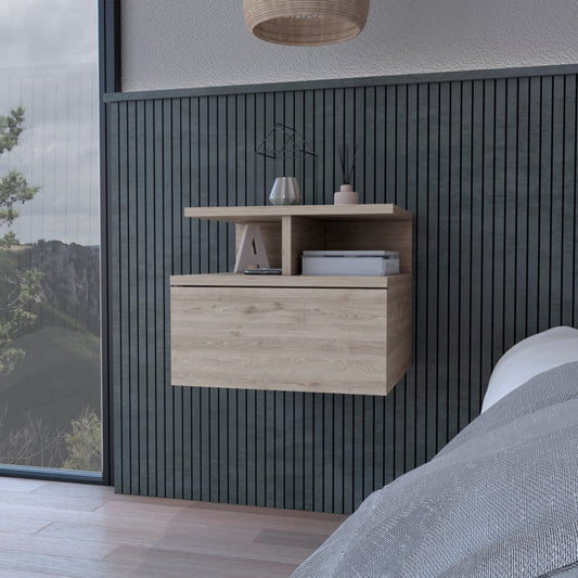 Grey floating bedside table on a wall next to a bed and a window