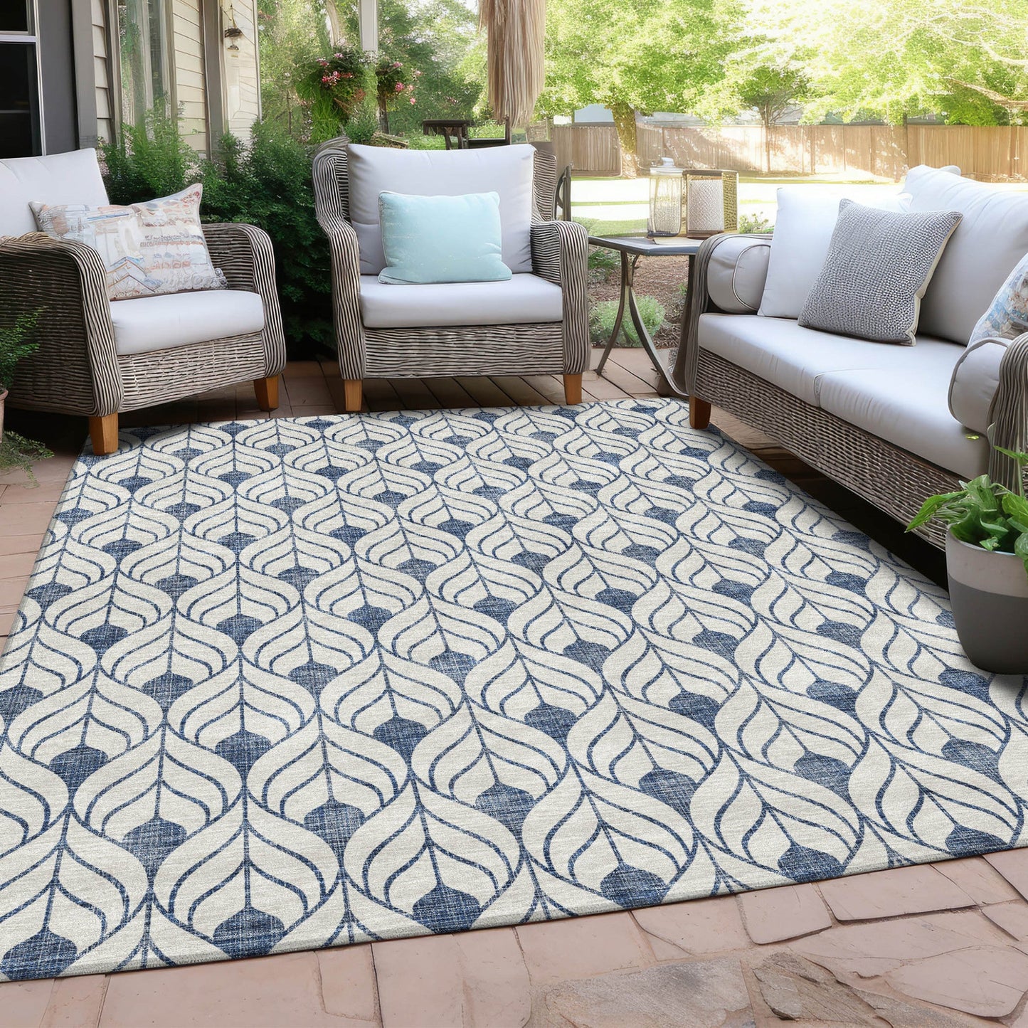 Blue and white pattern rug in front of a set of couches outside