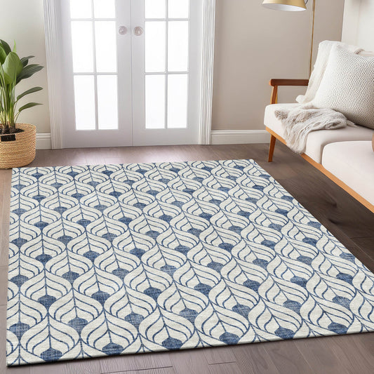 Blue and white pattern rug in front of a white couch and a double door