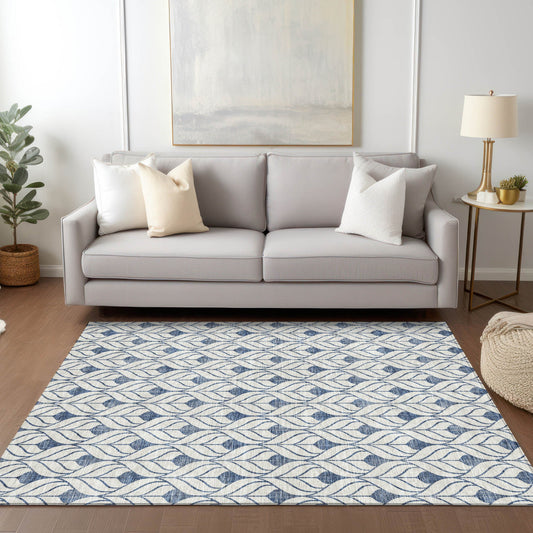 Blue and white pattern rug in front of a white couch