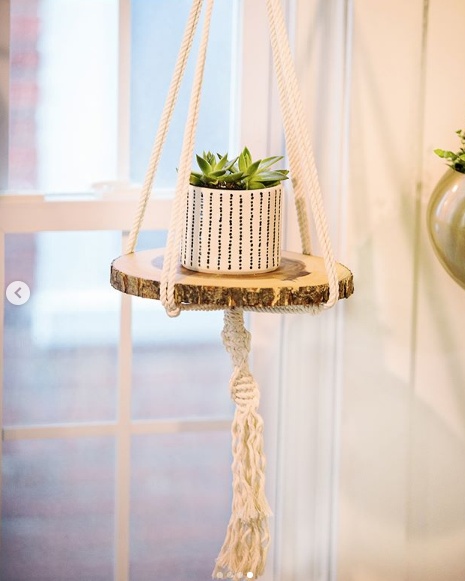 Macrame hanger plant pot with a plant and wooden base Striped plant pot