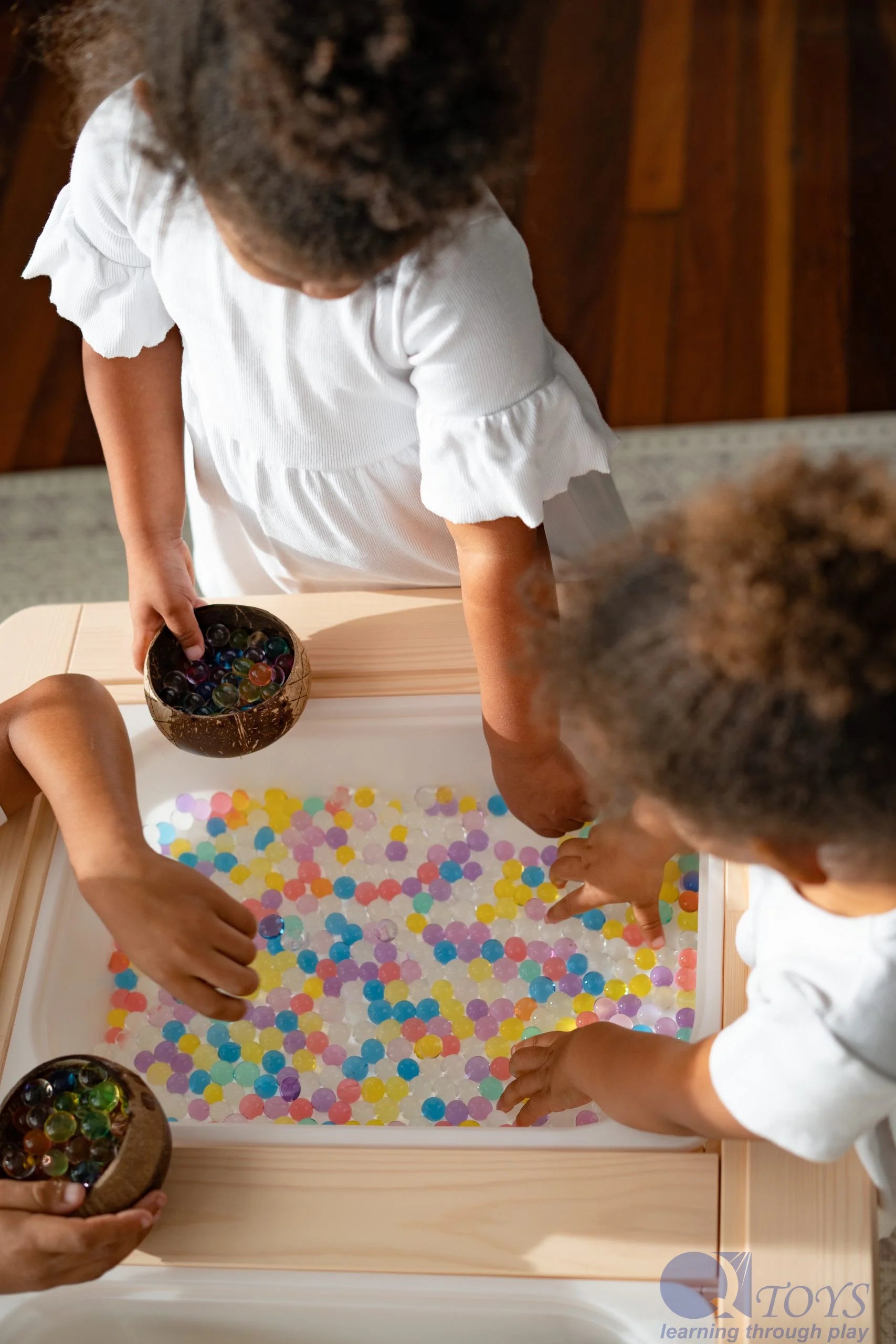 coconut bowls with kids playing with beads