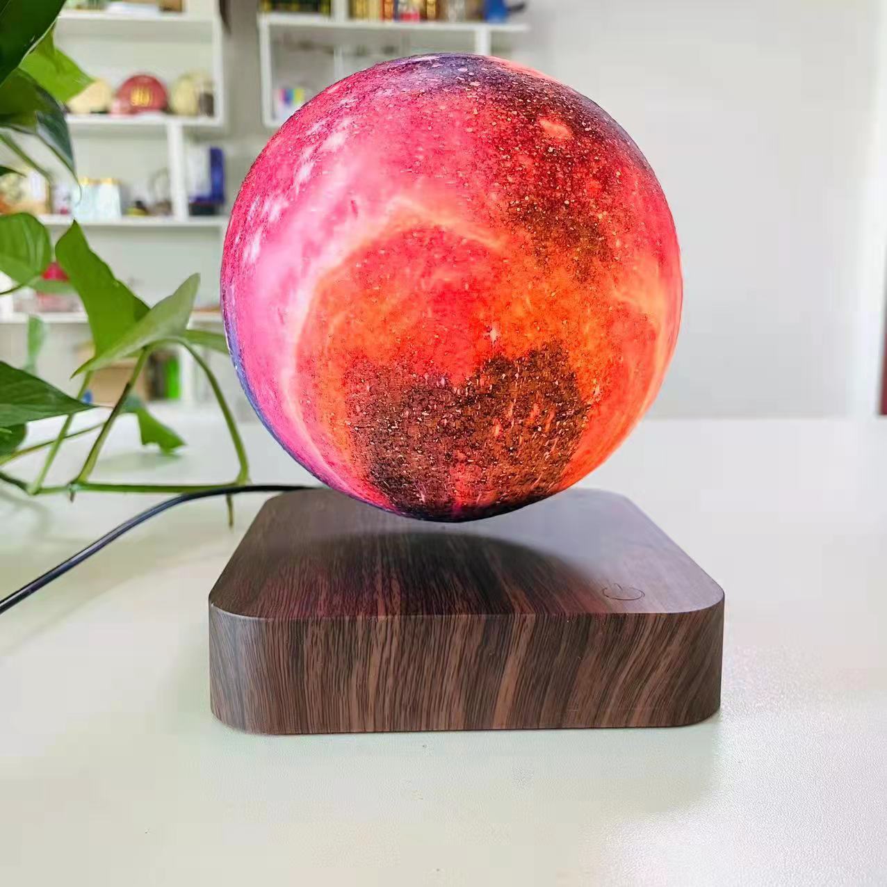 Galaxy sphere levitating on a wooden board