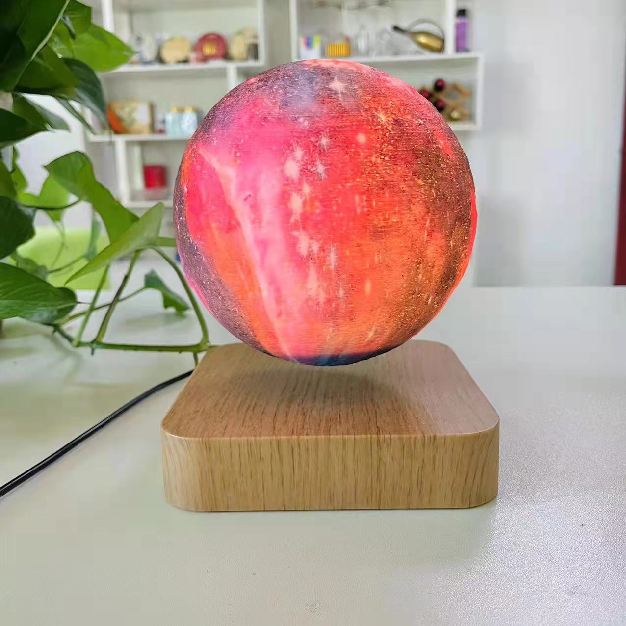 Galaxy sphere levitating on a wooden board