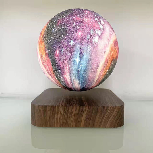 Galaxy sphere levitating on a wooden board