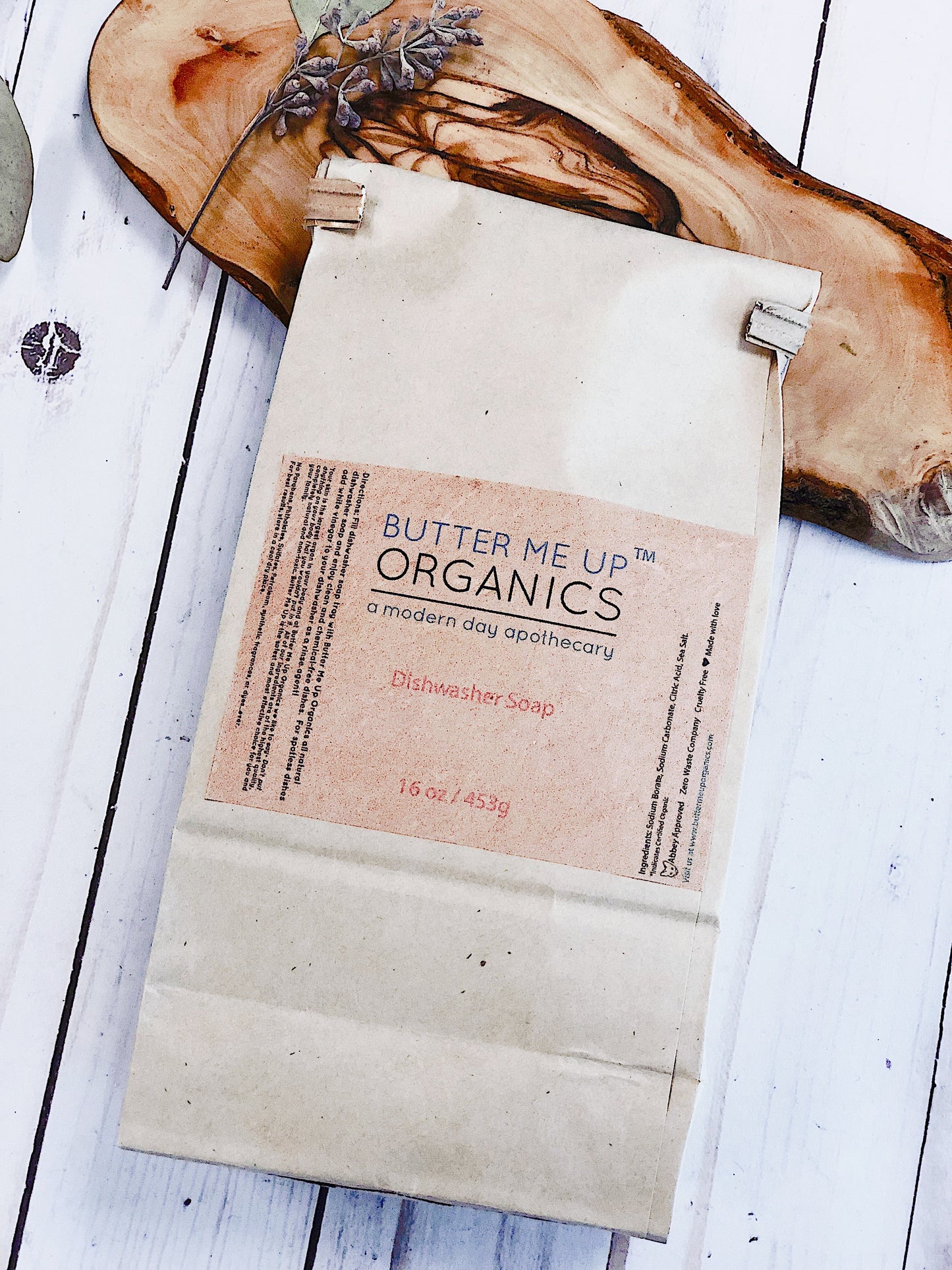 Paper Bag of dishwasher soap on wooden board