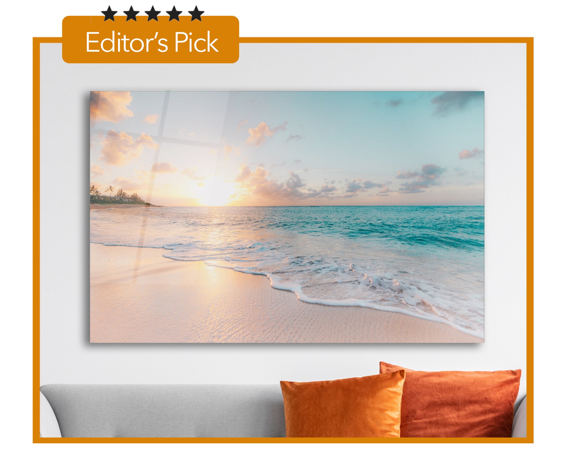 Beach wall art over a couch with orange pillows and framed with an orange line with the words Editor's pick