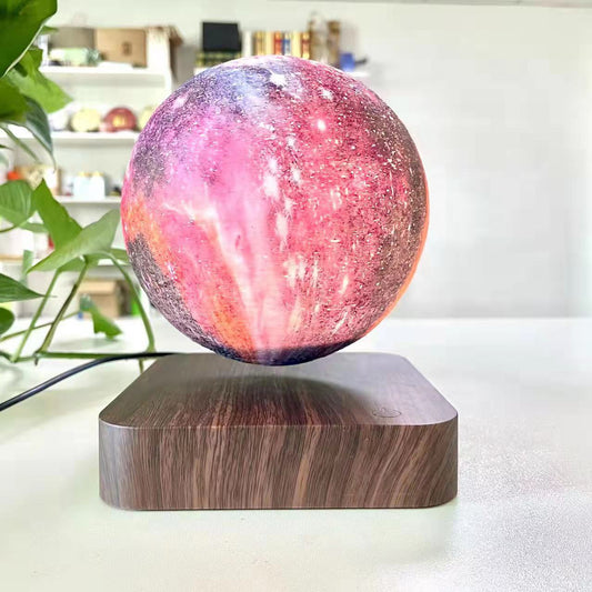 Galaxy sphere levitating on a wooden board