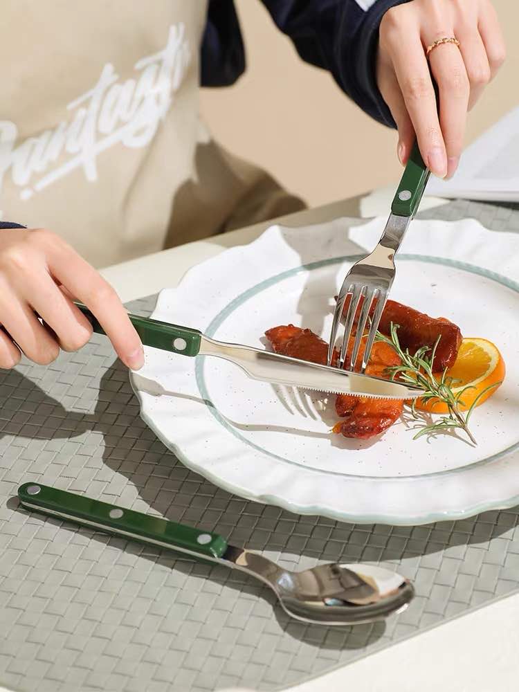 Fork, knife, spoon with a plate with food with hands